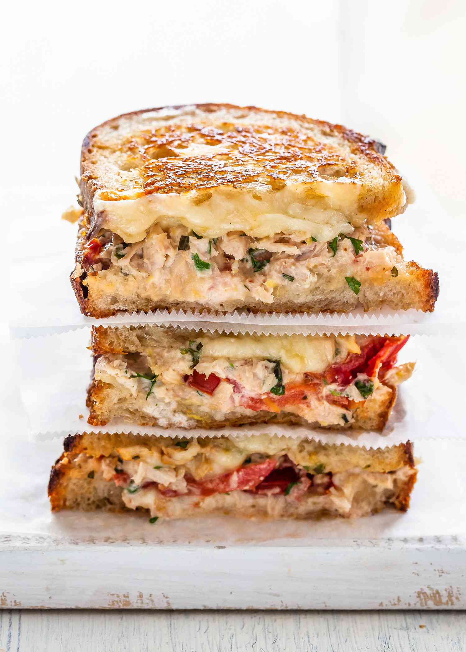 A stack of tuna melts sliced in half and ready to eat