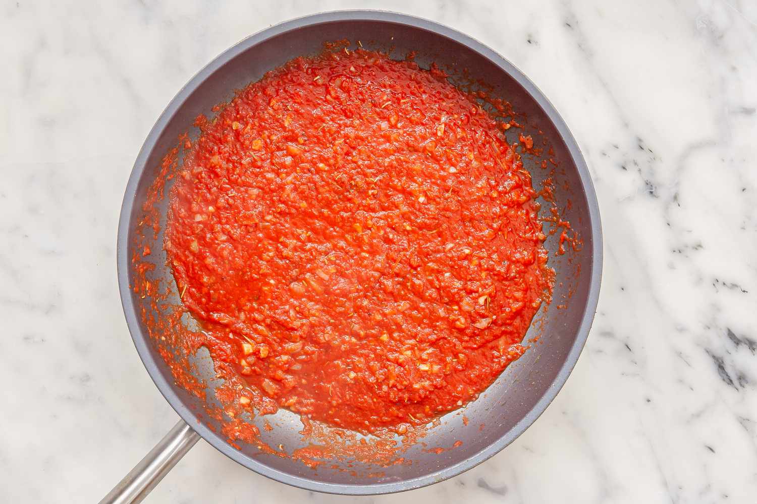 Sauce in a skillet to make Chicago-Style Deep Dish Pizza.