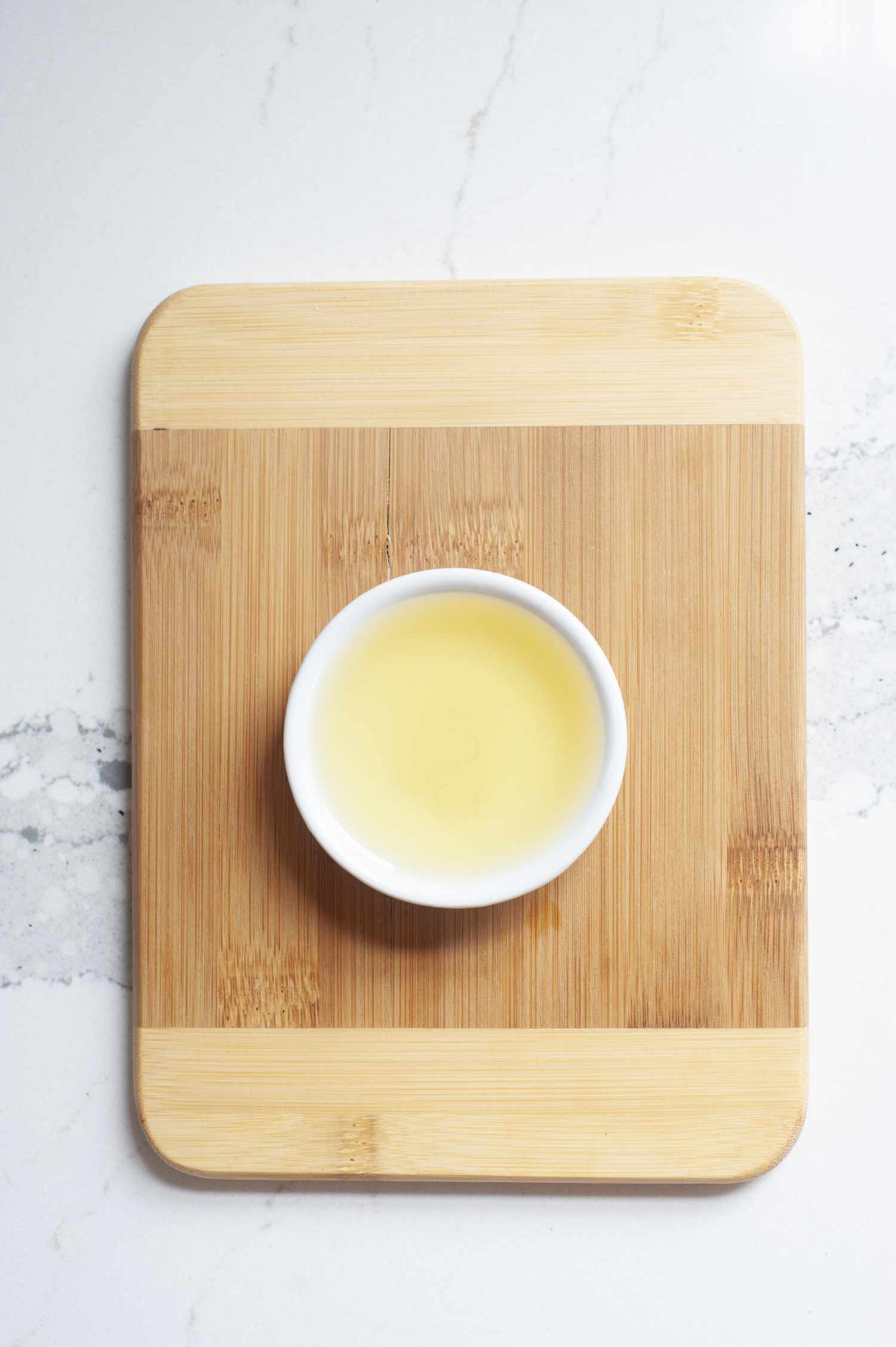 Light colored regular untoasted sesame oil in white bowl