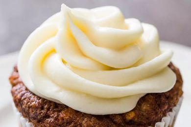 Cream cheese frosting piped on a cupcake