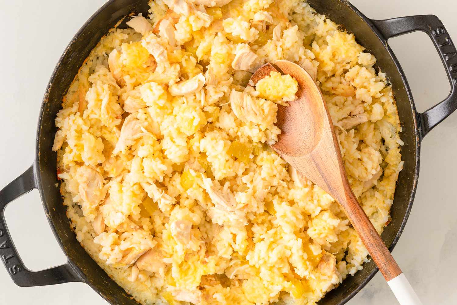 Overhead shot of a cast iron pot with a chicken and rice dish