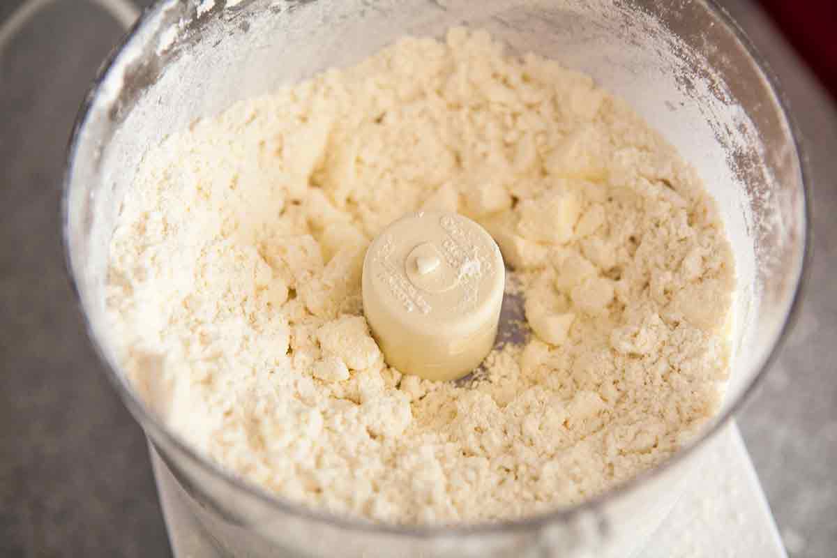 The food processor with crumbly dough to top a chicken pie.