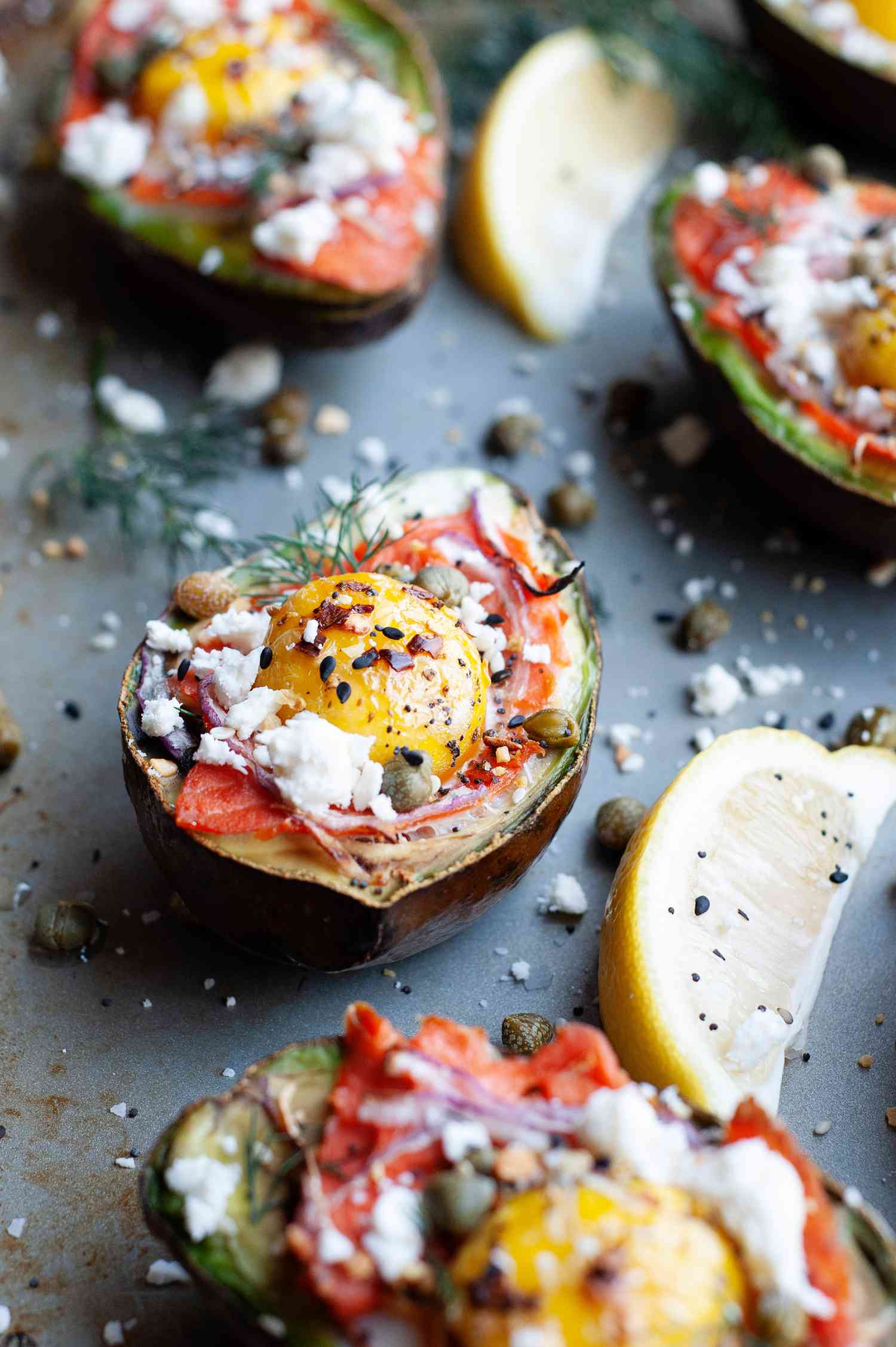 Everything bagel seasoned baked eggs in avocado on a sheet pan.