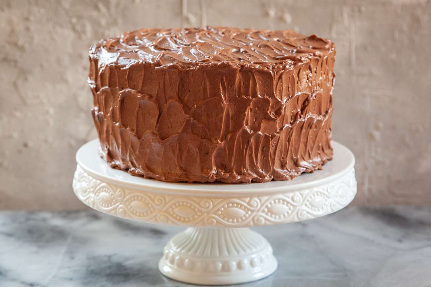 Decorated chocolate cake on a white cake stand