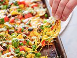 Pulling a loaded chip away from a sheet pan of nachos