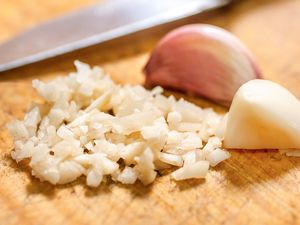 Garlic chopped on a wooden cutting board