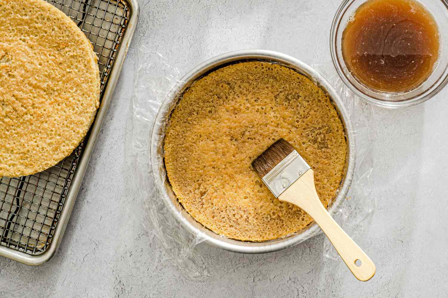 First cake layer in cake pan with soak.