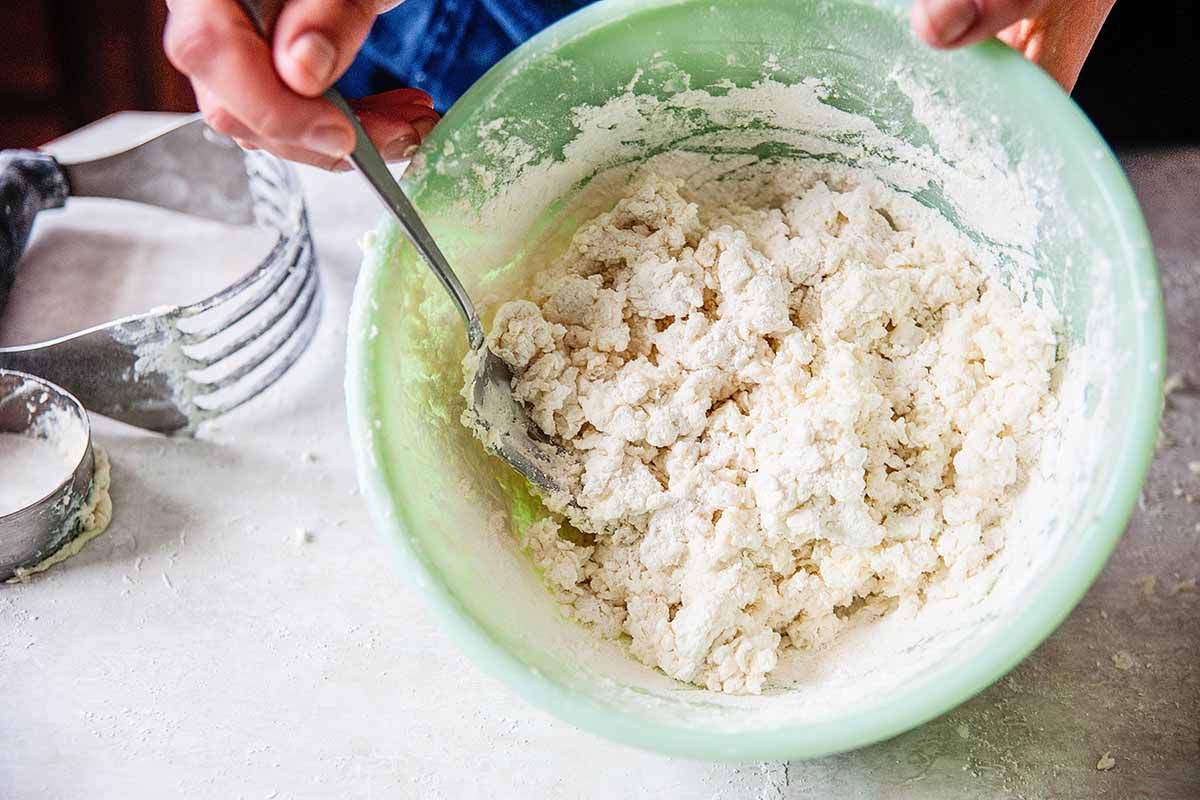Buttermilk Biscuits Recipe green bowl with shaggy dough