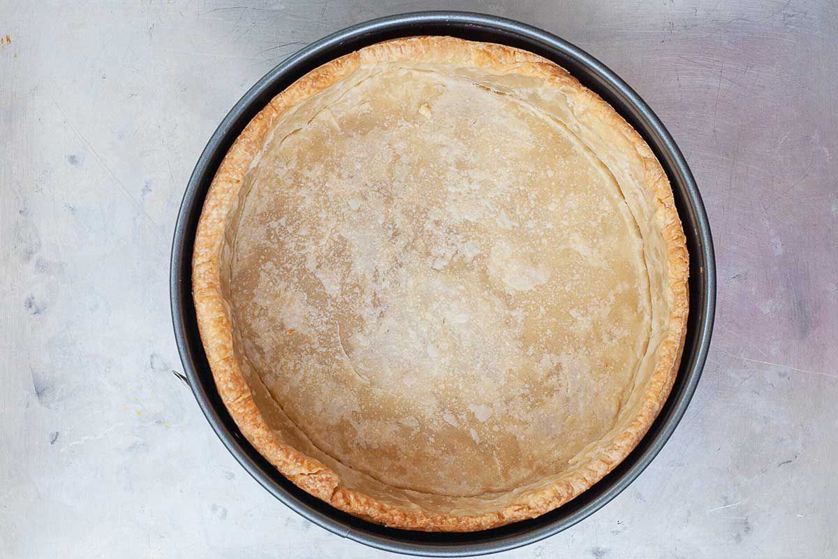 Mile high quiche crust baked in a springform pan.