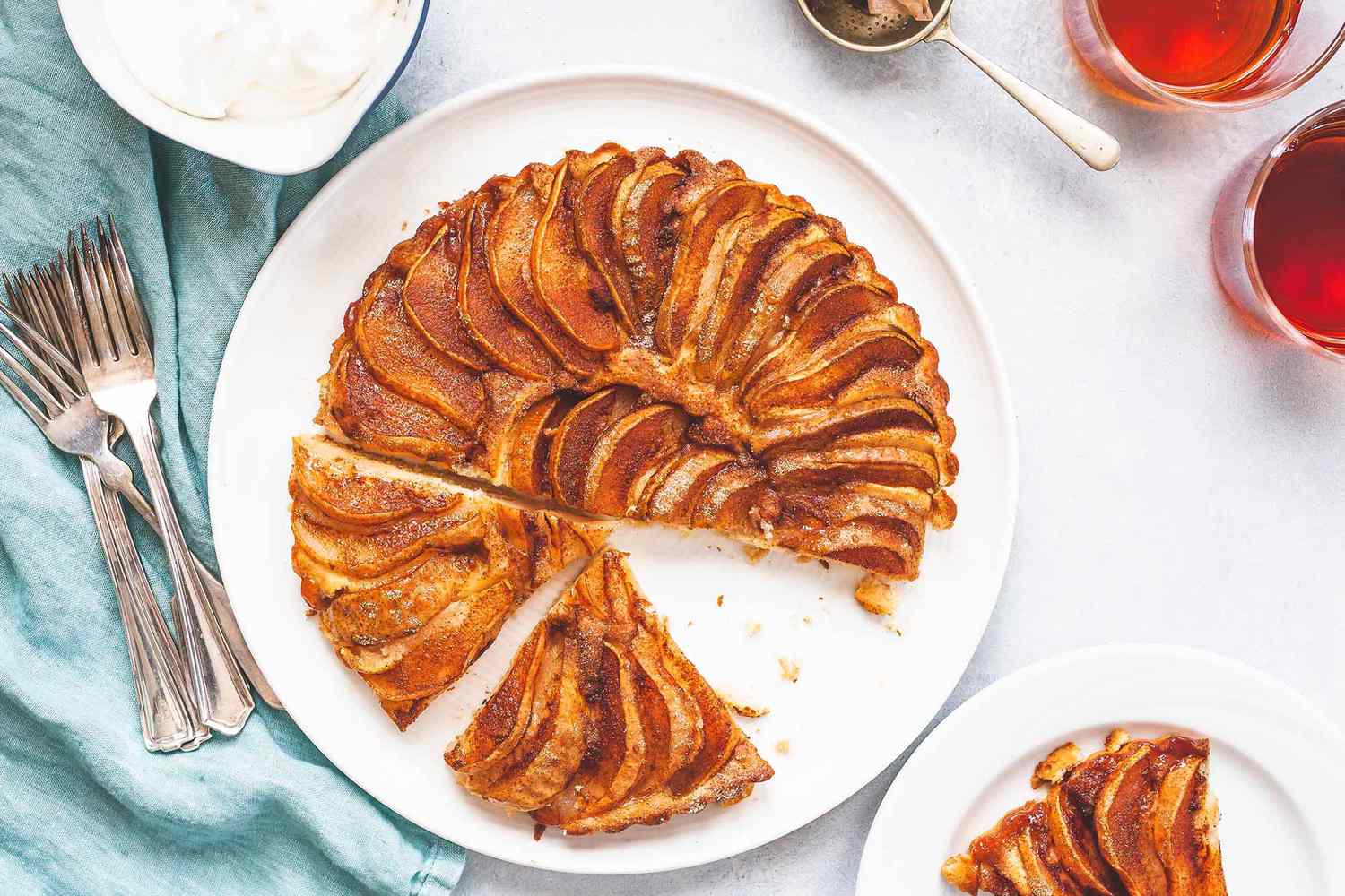 Pear cake with slices out on a plate.