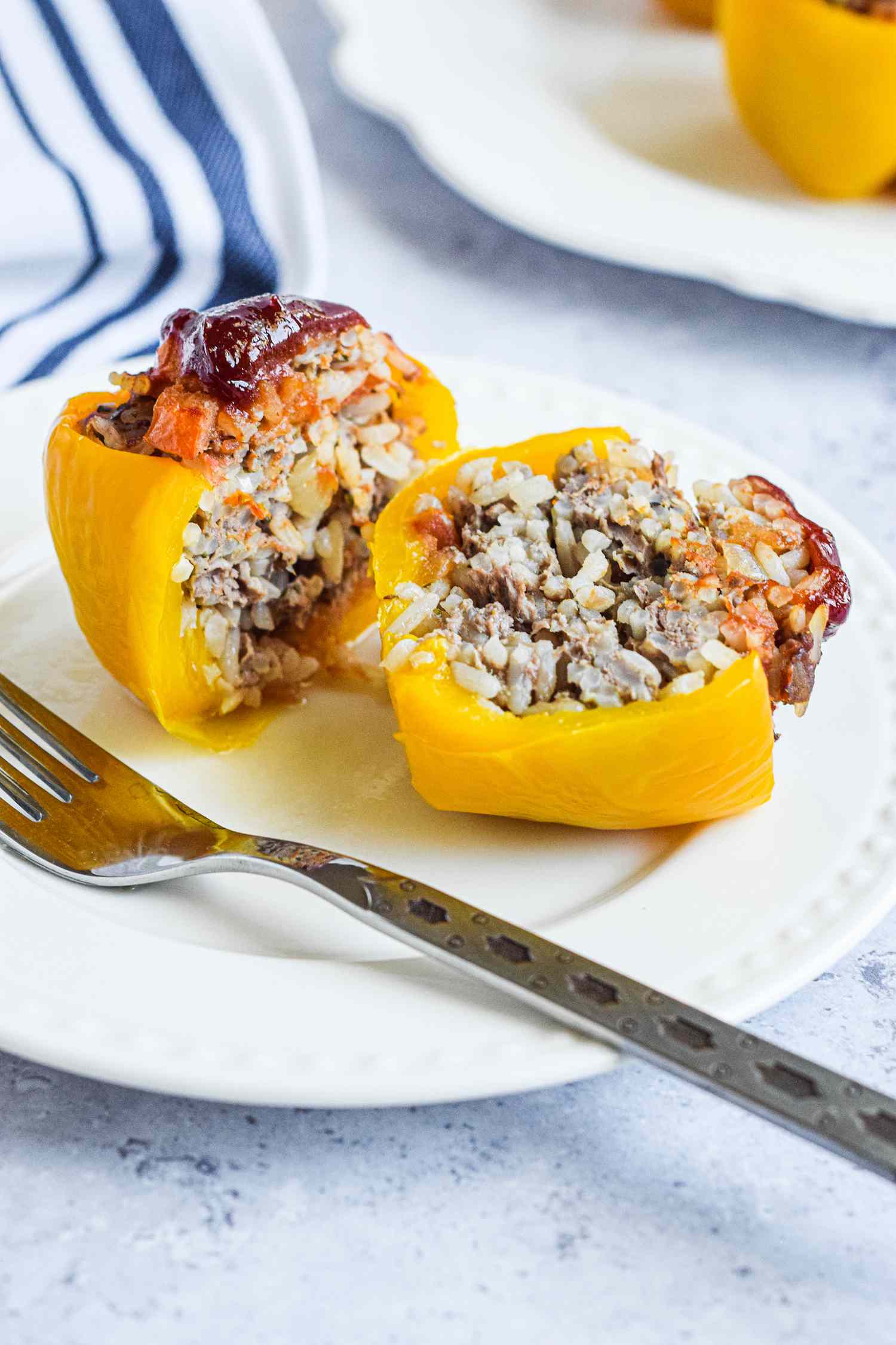Stuffed bell pepper sliced half on a plate to show the filling.
