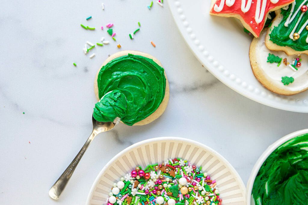 Green frosting and festive sprinkles for holiday cookies