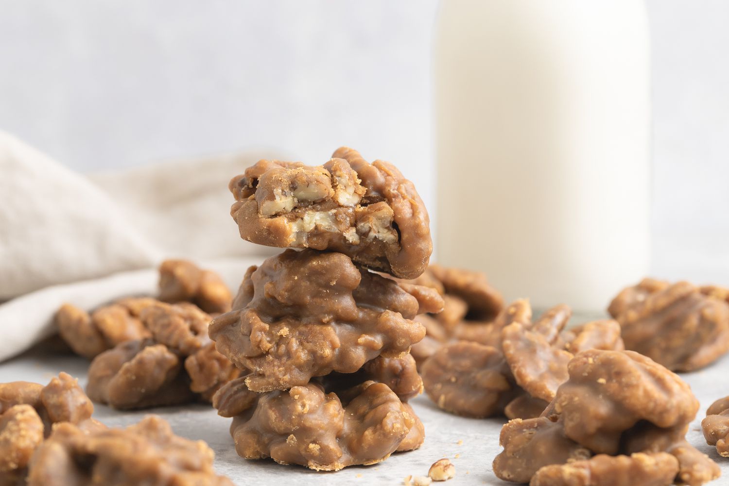 Pecan pralines stacked on top of each other.