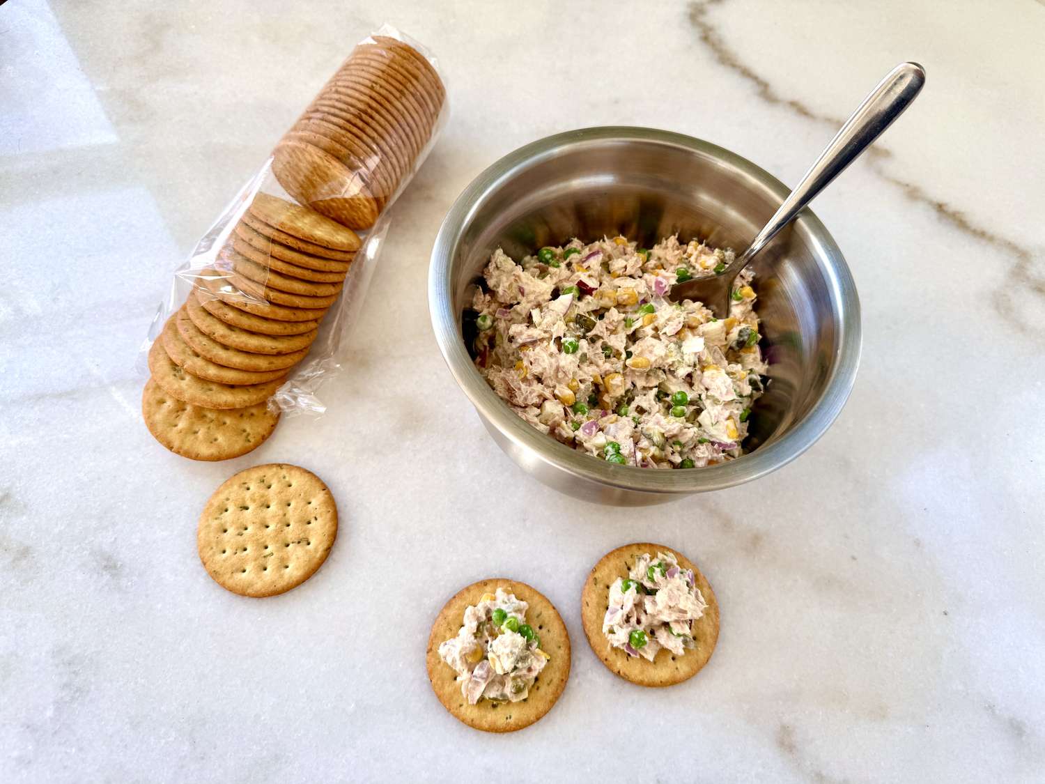 crackers and Matthew McConaughey's Tuna Salad in a bowl with a spoon