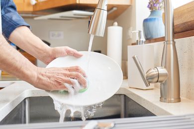 Washing dishes in sink