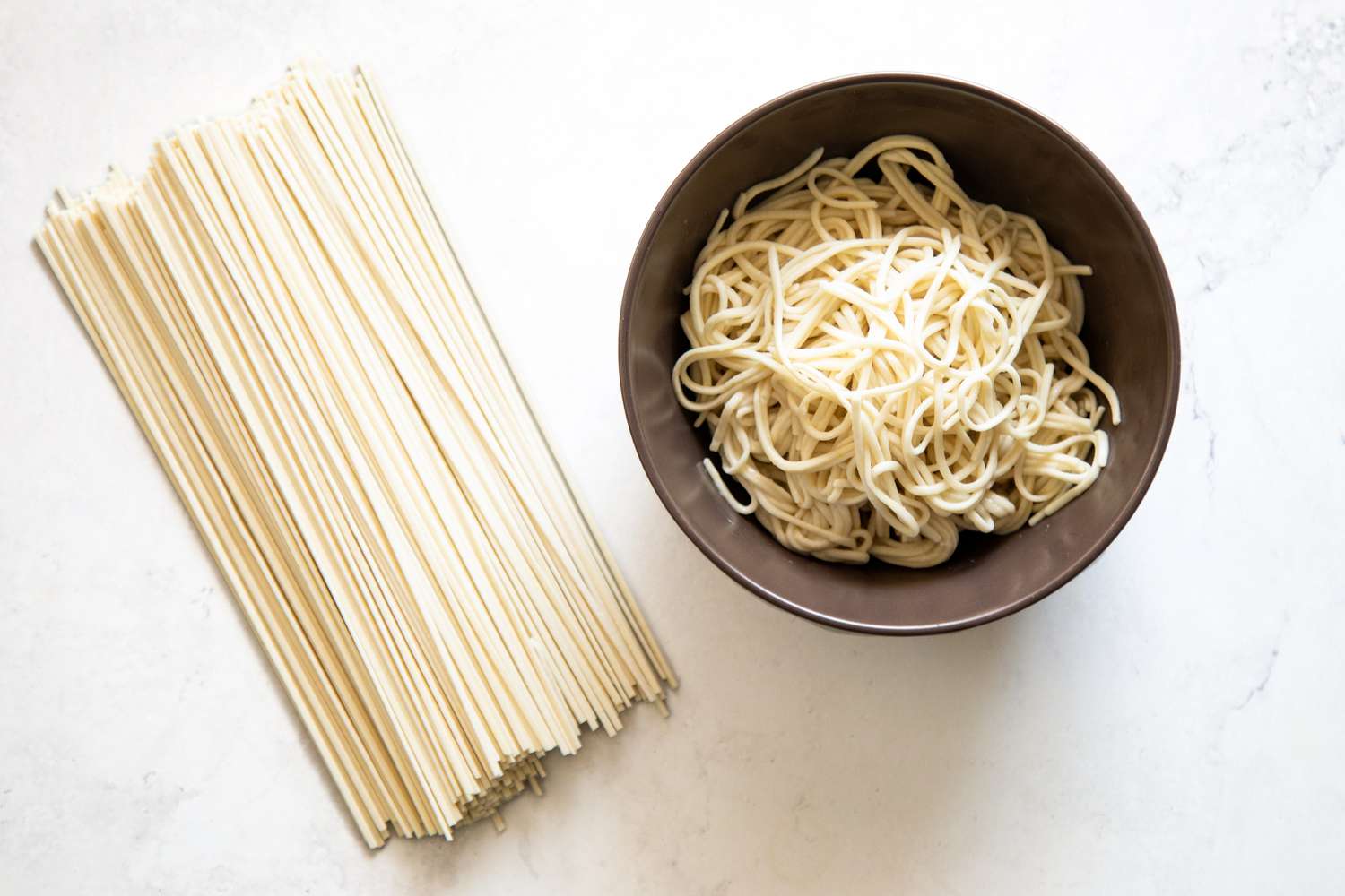 Dried Lo Mein on the Left and Cooked Lo Mein in a Bowl on the Right