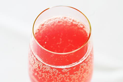 rosemary lemon rhubarb spritzer in a glass with a gold rim