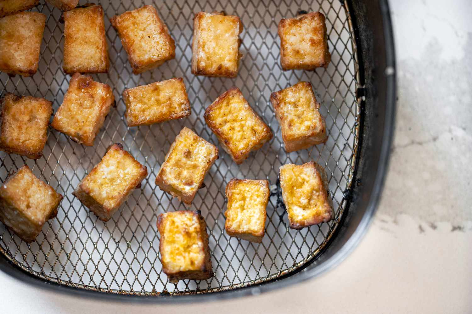 Crispy Air Fryer Tofu in Air Fryer Basin