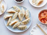 Overhead view of Korean pork and chives dumplings on a plate.