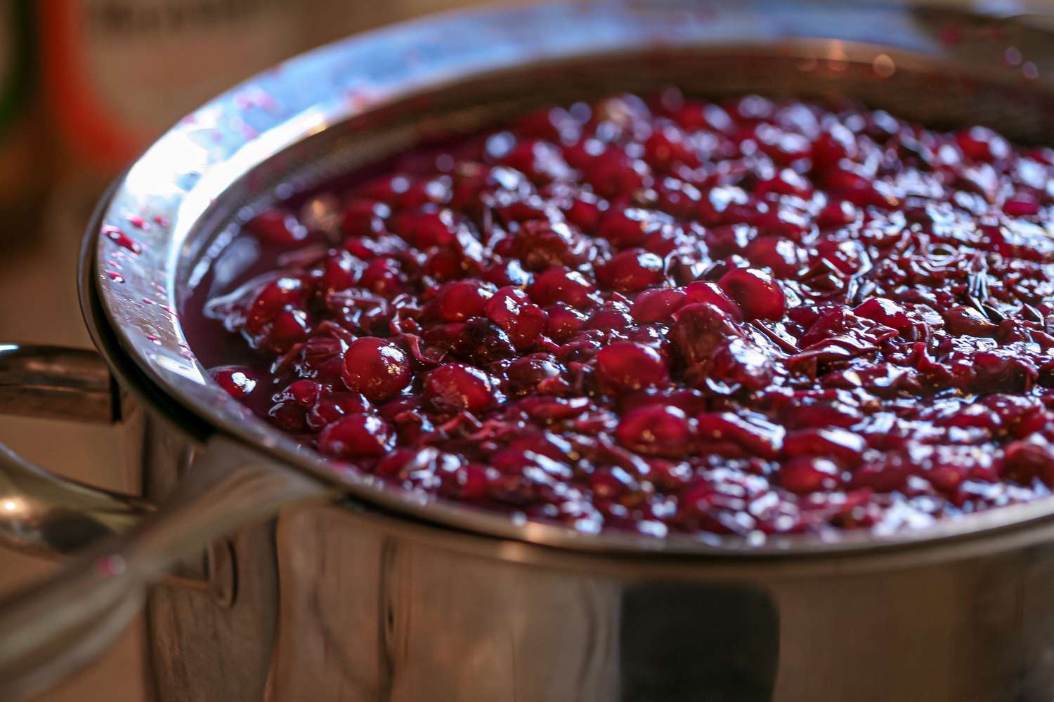 Straining concord grapes to make a grape drink.