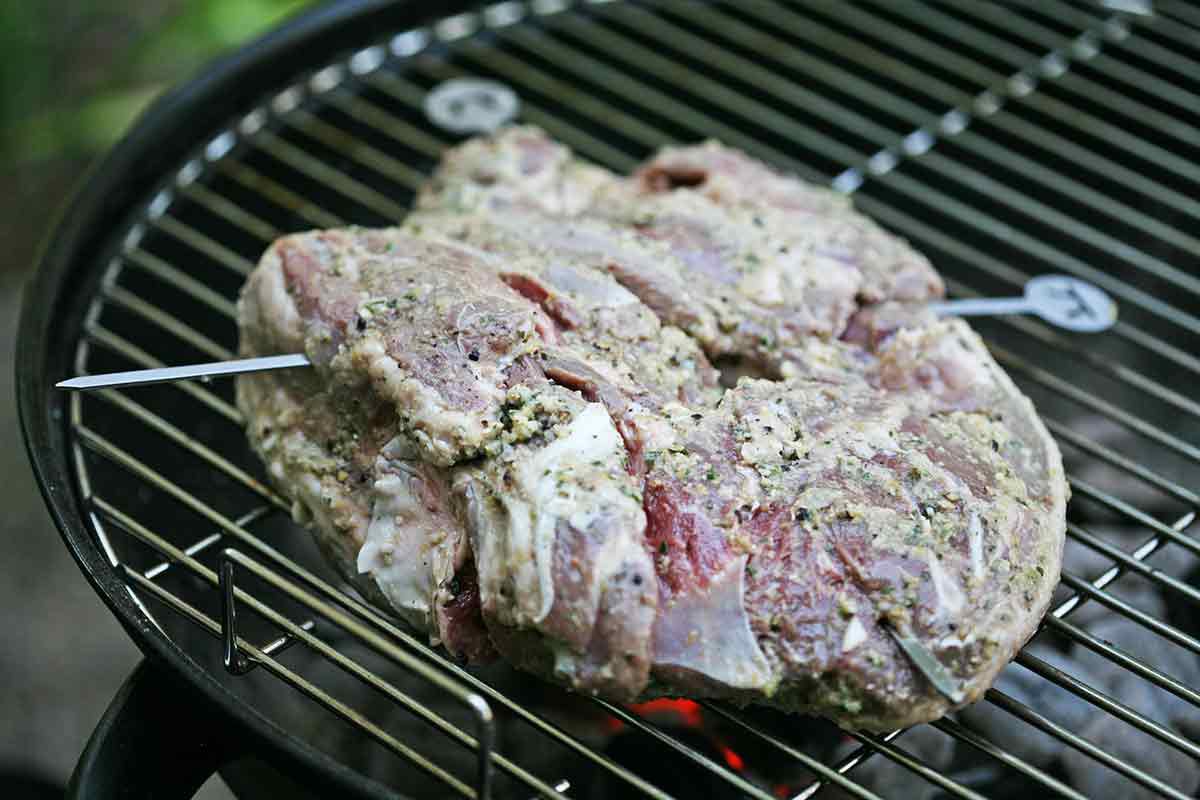 marinated butterflied leg of lamb on grill