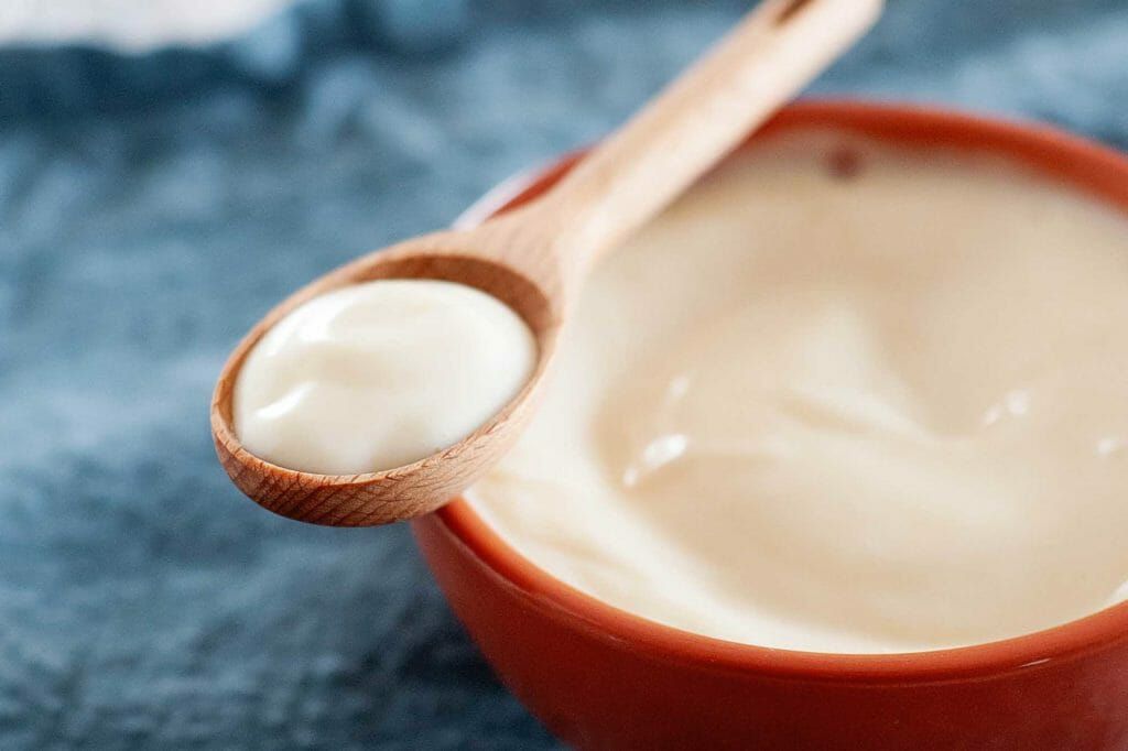 homemade mayonnaise on a wooden spoon