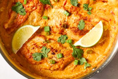 close-up, overhead view of Southwest Creamed Corn and Chicken Skillet, garnished with herbs, green onions, and lime slices