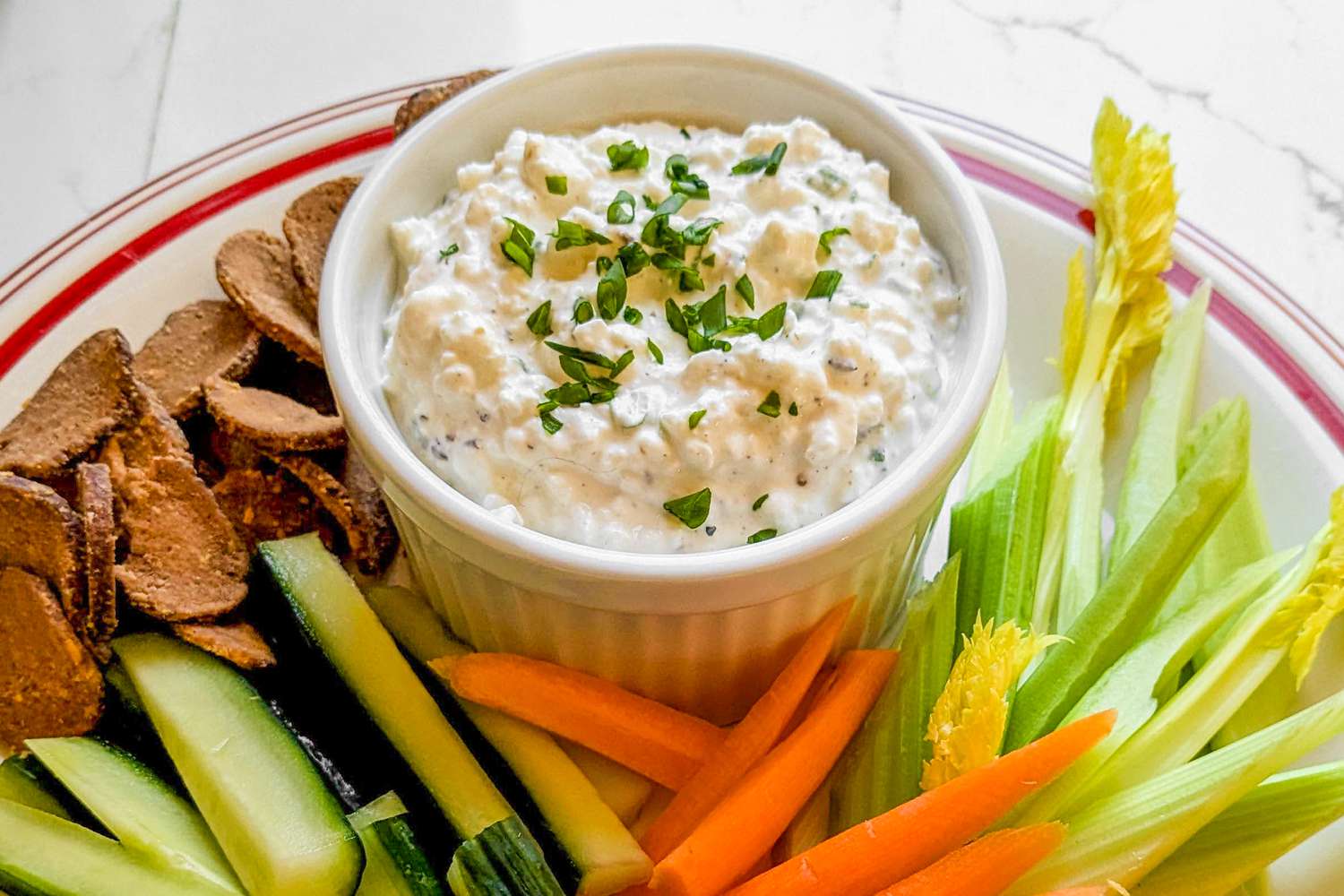 A plate of crudite with a spiced cottage cheese dip, ready to serve