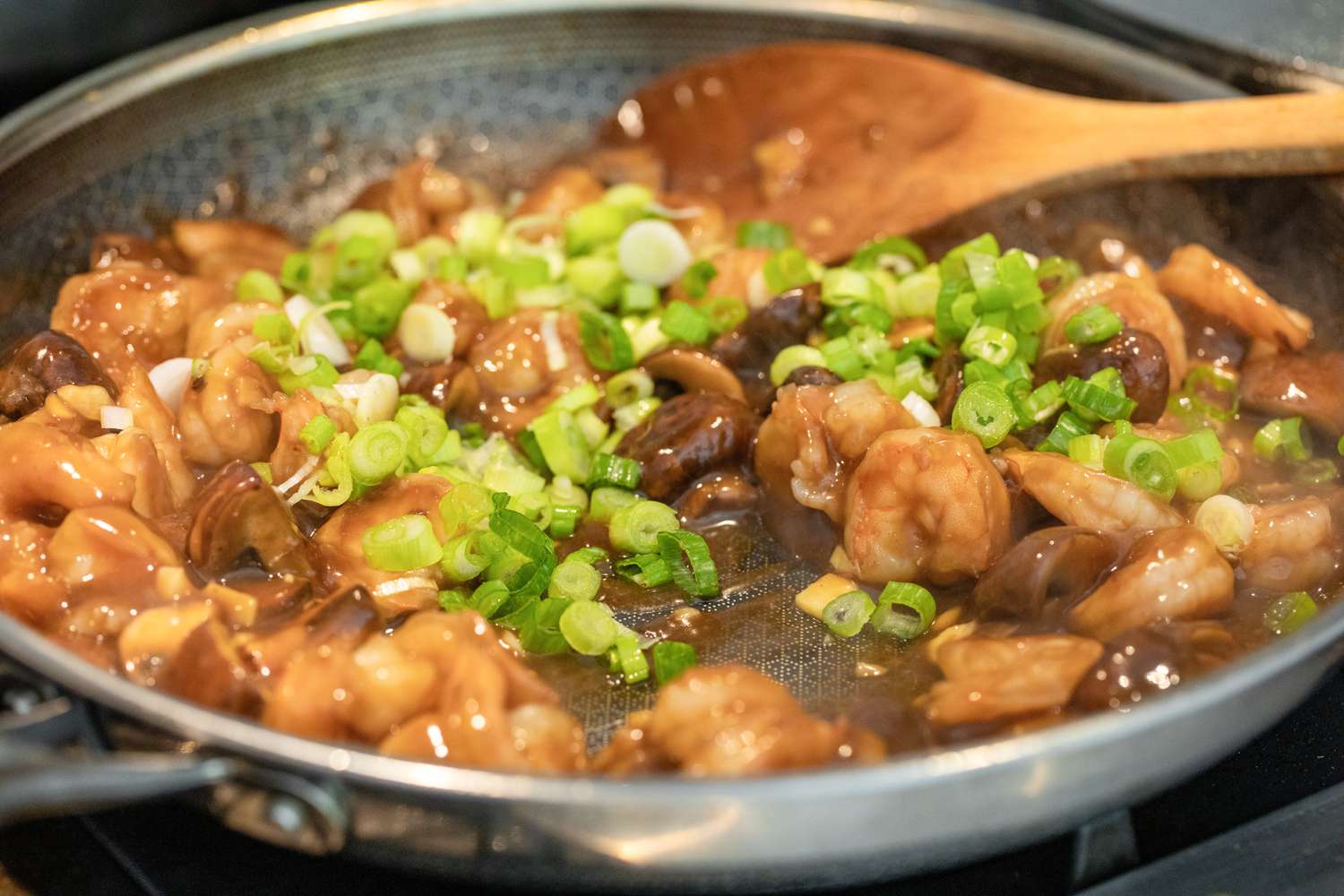 Sauce and Scallions Added to Shrimp and Mushroom Stir Fry in Skillet