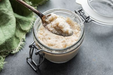 A jar of Homemade Prepared Horseradish with a spoon in it