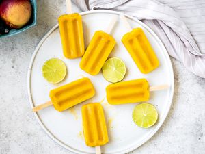 Peach Daiquiri Popsicles on a Plate with Lime Circles