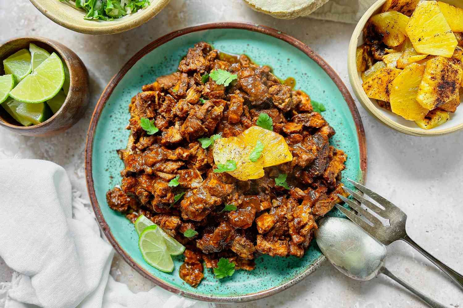 Plate of Tacos al Pastor Meat Surrounded by Other Ingredients for Tacos
