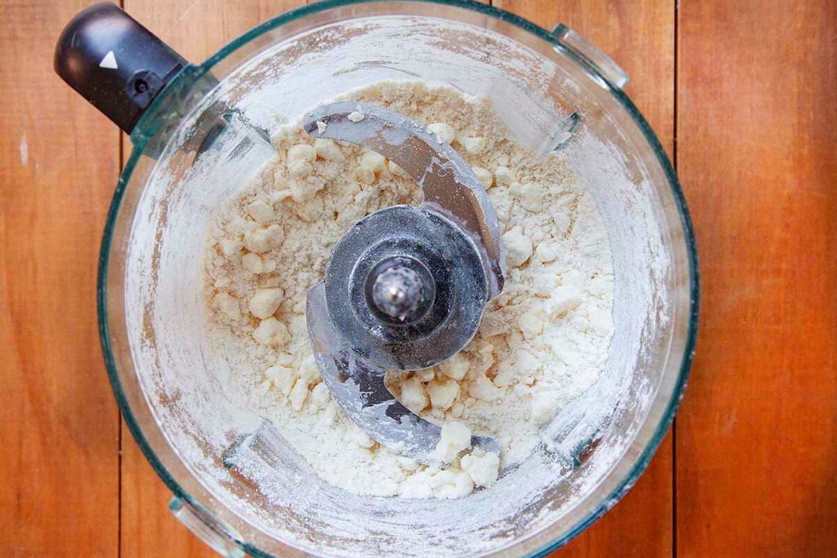 Flour mixed with butter inside a food processor to make shoo-fly pie.
