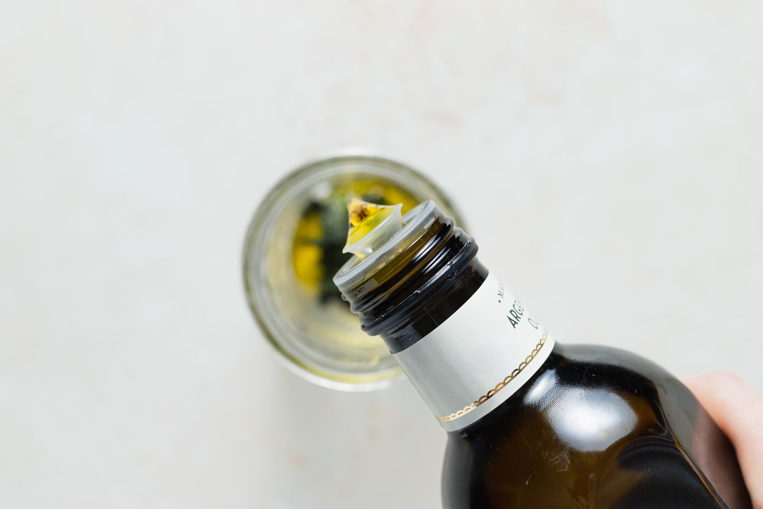 Adding oil to the mint to make a wax beans recipe.
