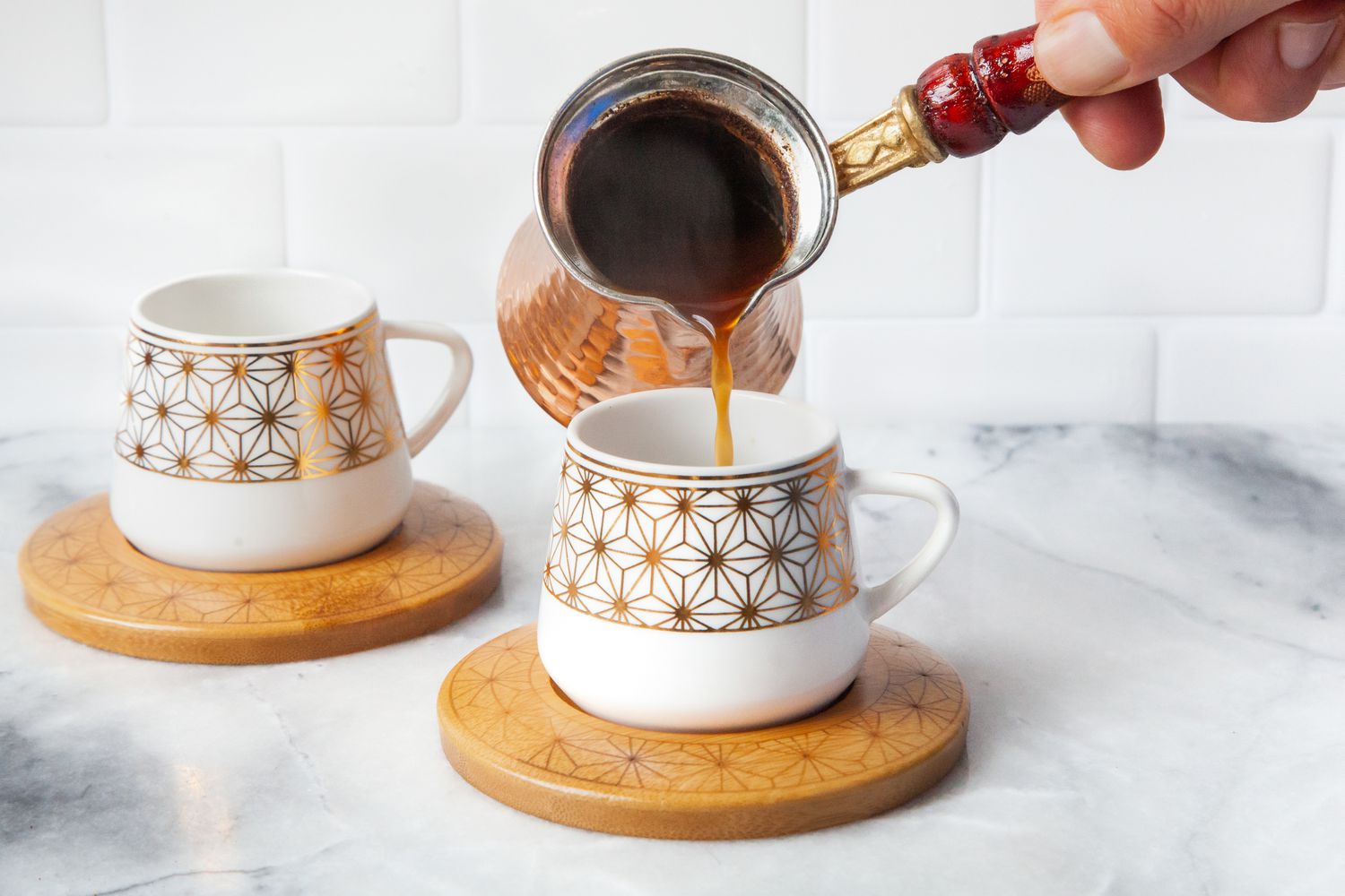 Turkish Coffee Poured into a Cup on a Coaster from a Cezve 