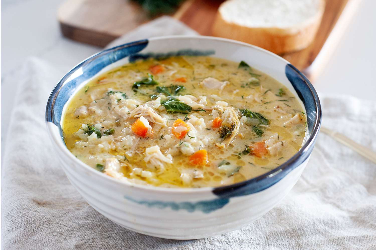 Yasmin Khan’s Lemon Chicken Soup in a bowl with a white linen underneath it.