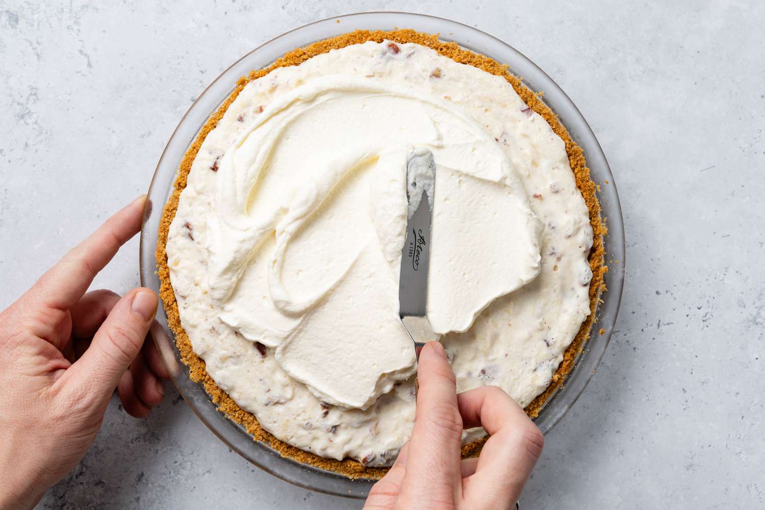 Whipped Cream Spread on the Million Dollar Pie Using an Offset Spatula
