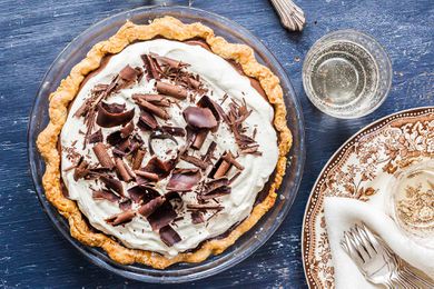 A whole chocolate pie topped with shaved chocolate.