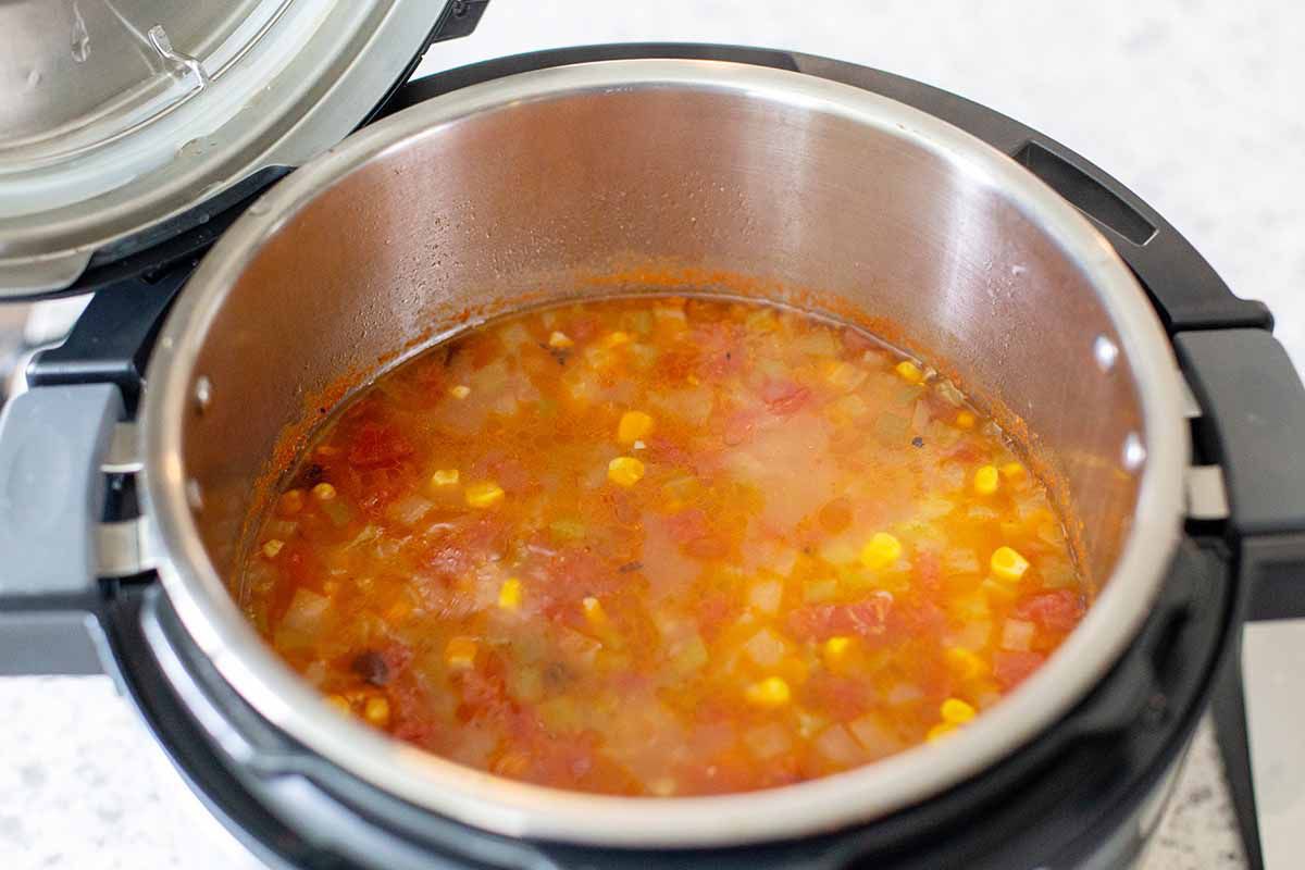 Horizontal photo of the inside of an open instant pot with the best instant pot chicken tortilla soup inside.