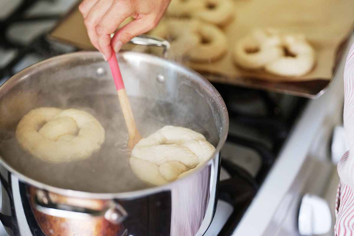 Lift the pretzels out of the water bath with a slotted spoon