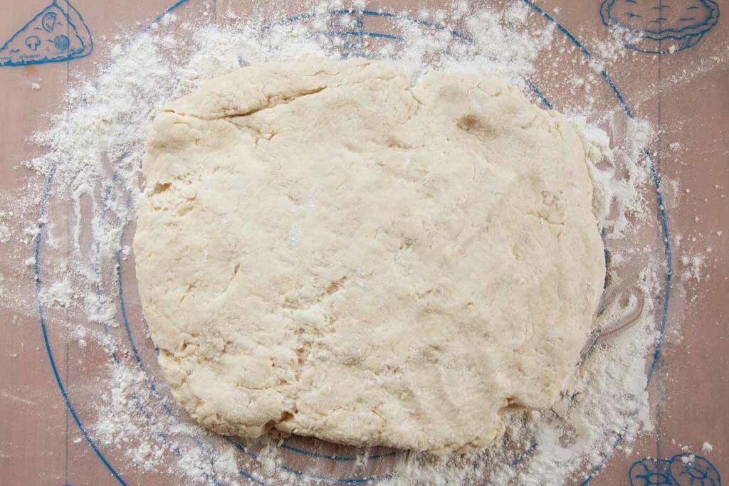 Fold angel biscuit dough on floured surface