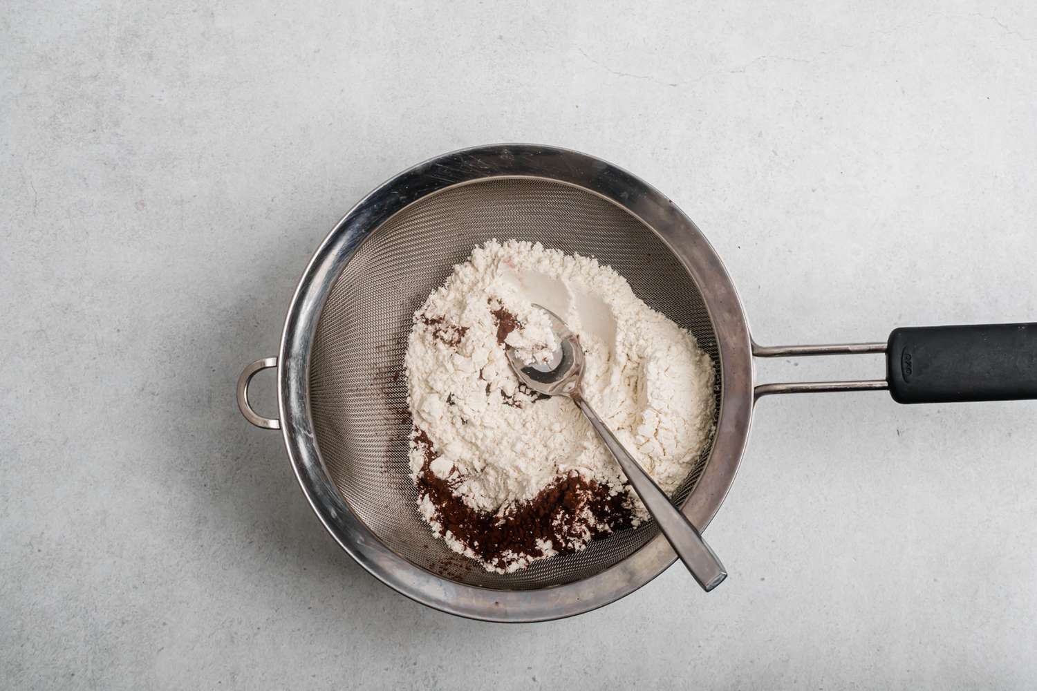 Sifting dry ingredients for simple chocolate shortbread.