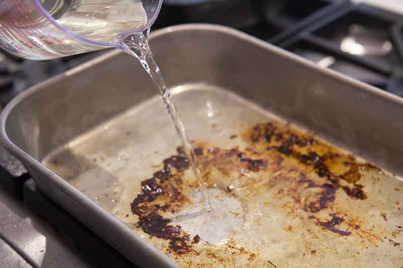 Making pan sauce with drippings for pork roast