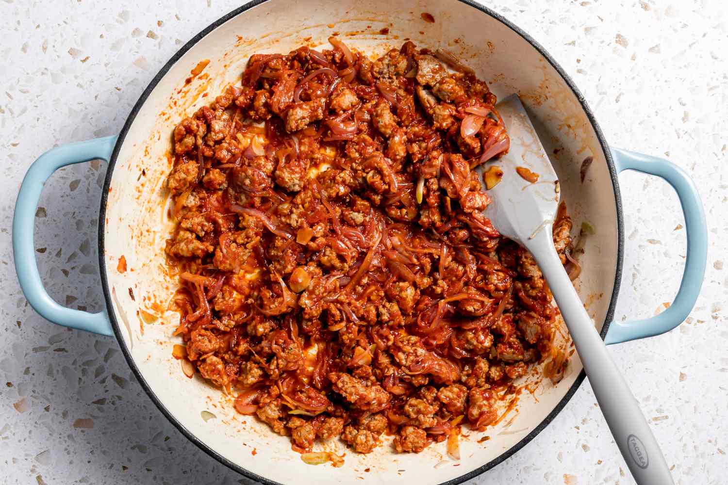Tomato Paste Added to Pot and Mixed Until Sausage, Onions, and Garlic Are Covered in Paste