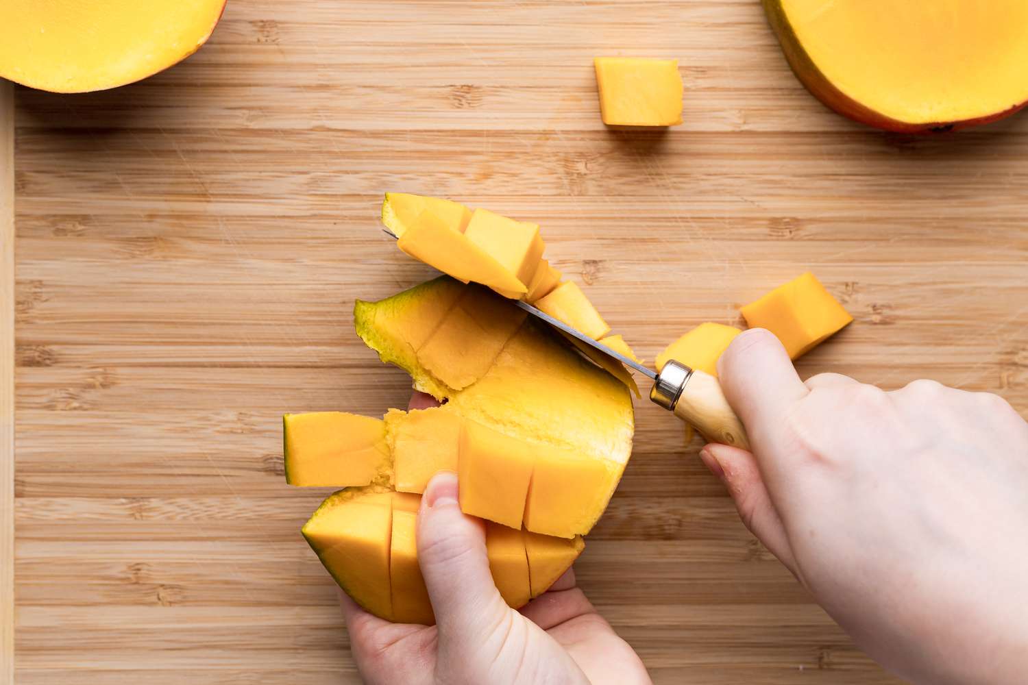 Showing how to peel a mango.