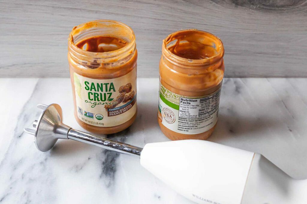 Using an immersion blender to stir mix natural peanut butter