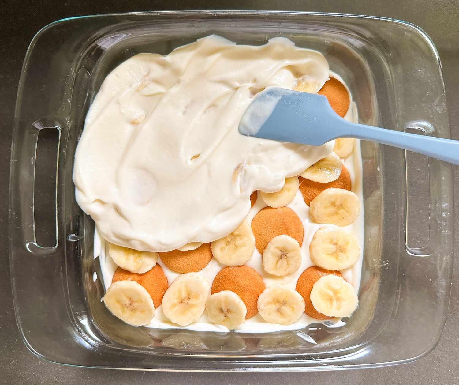 Spreading pudding on bananas and Nilla wafers