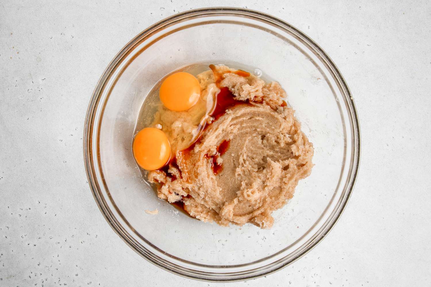 Eggs and vanilla added to creamed butter and sugar for easy chocolate chocolate cookies.