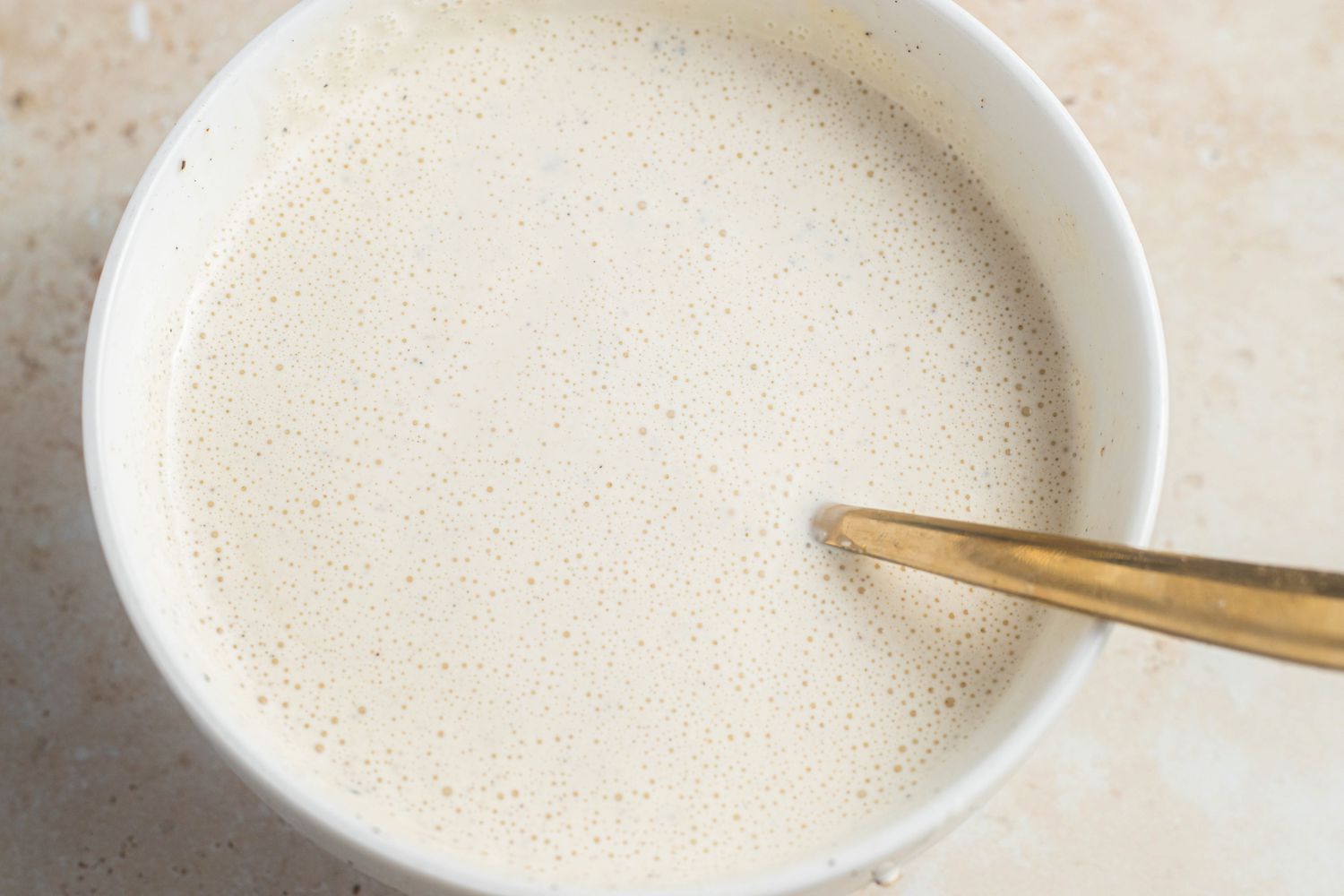 Bowl of Dressing With a Spoon for Chicken and Rice Recipe