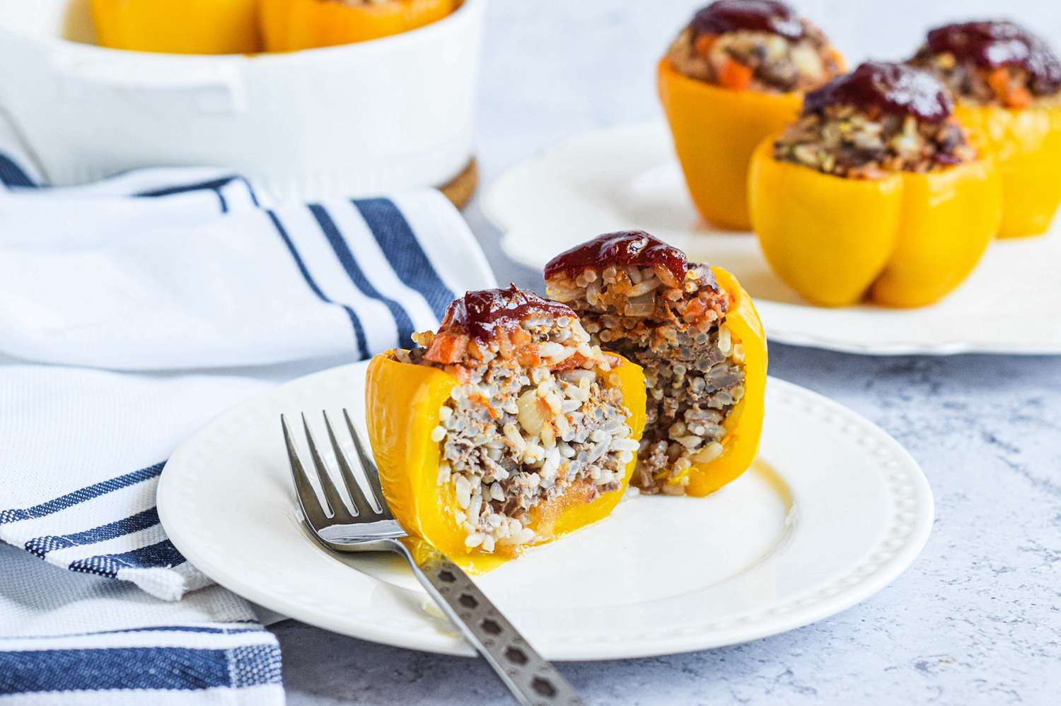 Stuffed bell pepper sliced half on a plate to show the filling.